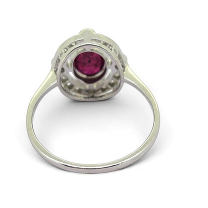 Ruby and Diamond Halo Cluster Engagement Ring, 0.70ct oval red ruby surrounded by fixed halo of diamonds with larger diamonds at the four compass points in 18ct white gold