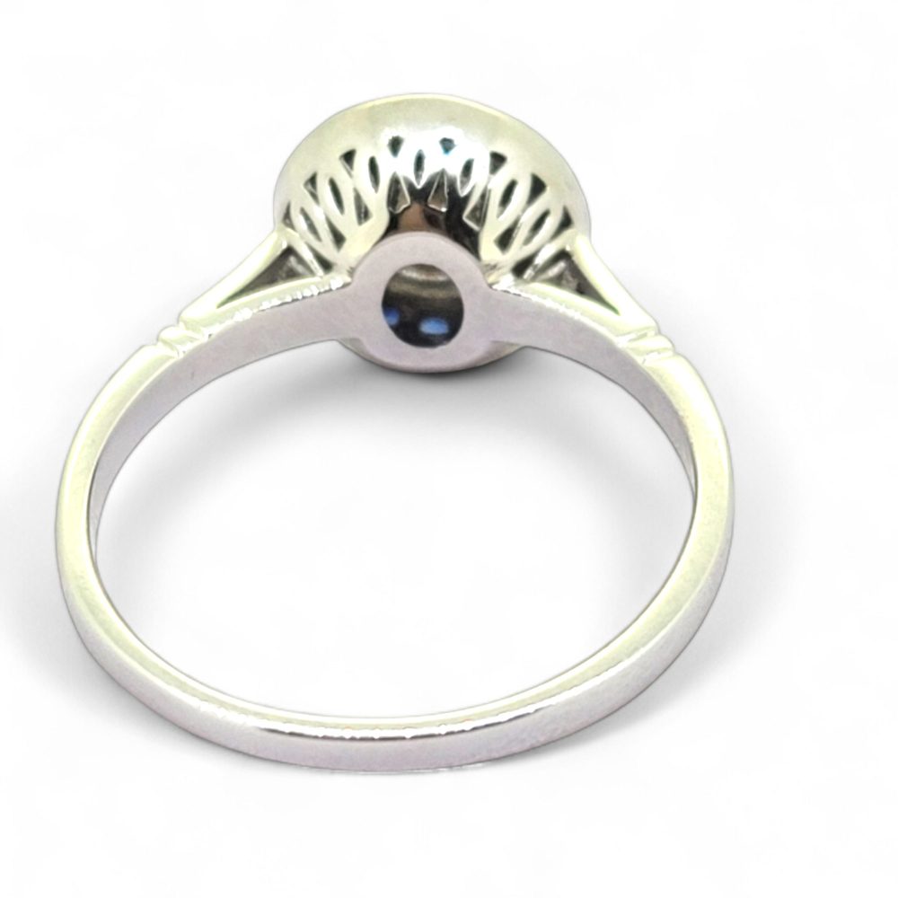 0.53ct Diamond and Sapphire Target Engagement Ring, 0.53ct round brilliant-cut diamonds surrounded by a halo of calibre sapphires in 18ct white gold