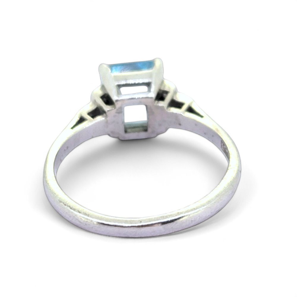 Aquamarine and Diamond Engagement Ring, rectangular step-cut aquamarine flanked by stepped brilliant-cut diamond-set shoulders in 18ct white gold