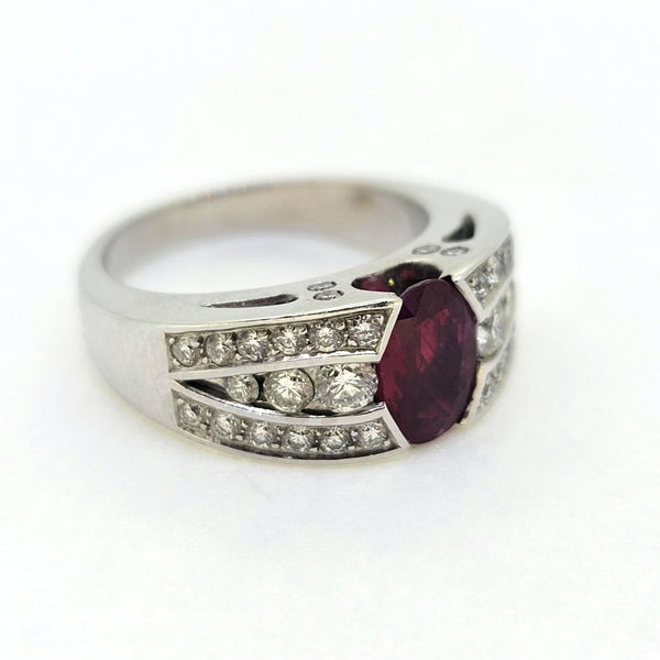 Romain Herzo 1ct Ruby and Diamond Ring, 1ct oval red ruby flanked by three row split diamond shoulders in 18ct white gold