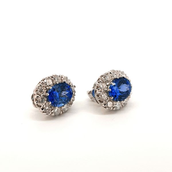 Tanzanite and Diamond Oval Cluster Stud Earrings; featuring 5.60cts oval faceted tanzanites within 2.05cts brilliant-cut diamond surrounds, in 18ct white gold