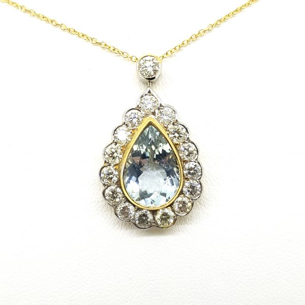 Aquamarine and Diamond Pear Shaped Cluster Pendant; 3.25ct pear-cut aquamarine within diamond surround and suspended from a diamond-set bale, in 18ct yellow and white gold