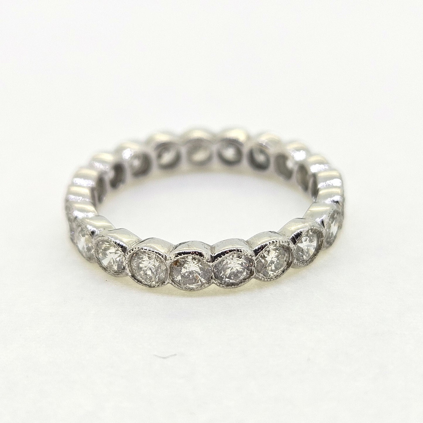 A diamond full eternity ring in 18ct white gold, on a white background