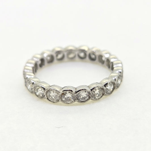 A diamond full eternity ring in 18ct white gold, on a white background