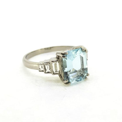 Aquamarine and Baguette Diamond Dress Ring in Platinum, central 2.60ct emerald-cut aquamarine flanked either side by three graduated baguette-cut diamonds