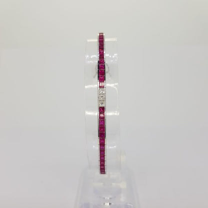 Princess Cut Ruby and Diamond Line Bracelet; 8.13cts princess-cut rubies accented with 1.05cts princess-cut diamond set sections, in 18ct white gold