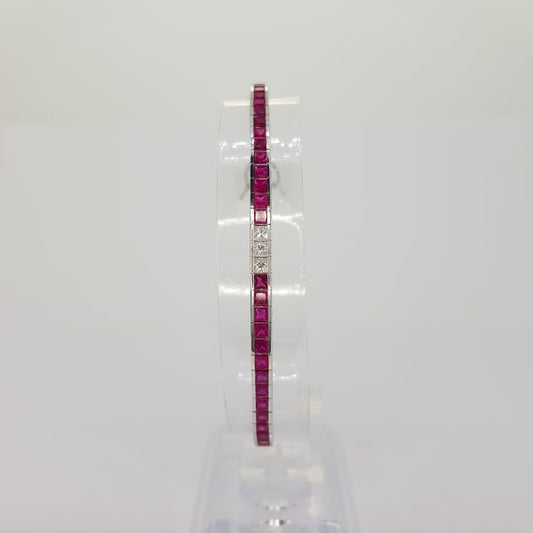 Princess Cut Ruby and Diamond Line Bracelet; 8.13cts princess-cut rubies accented with 1.05cts princess-cut diamond set sections, in 18ct white gold