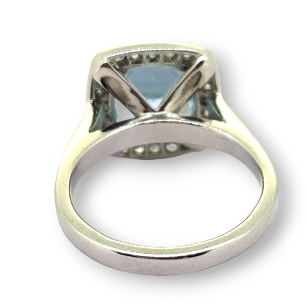 3ct Aquamarine and Diamond Cluster Engagement Ring in Platinum, 3ct aquamarine framed by a halo of round brilliant-cut diamonds in platinum with diamond-set shoulders