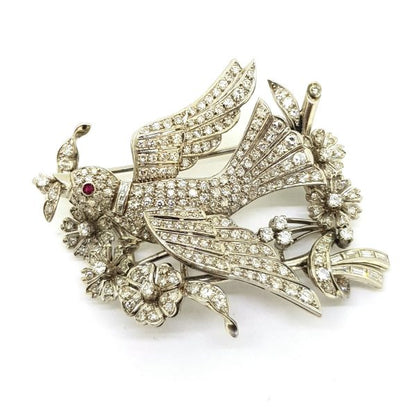 Entremble Diamond Bird Brooch, 5.00 carat total, featuring a bird in mid-flight within a flower and spray design set with 5cts baguette and brilliant-cut diamonds, in platinum and 18ct gold