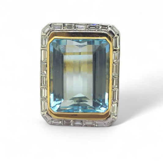 25ct Aquamarine and Baguette Diamond Cluster Ring, large 25cts emerald-shaped step-cut aquamarine bezel set in yellow gold with outer border of baguette-cut diamonds