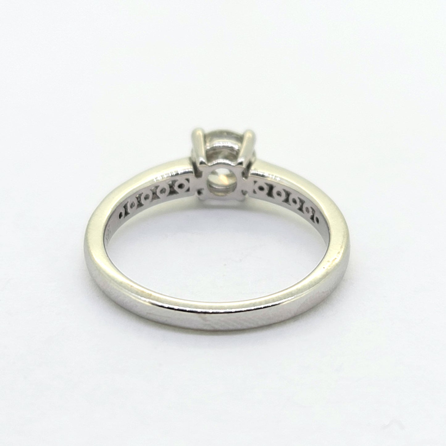 A brilliant and baguette cut diamond ring in white gold, against a white background