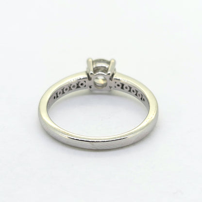 A brilliant and baguette cut diamond ring in white gold, against a white background