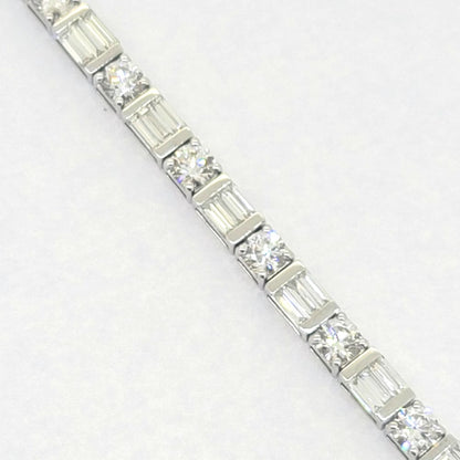 Baguette and Brilliant Cut Diamond Line Tennis Bracelet, set with 6.40 carats of round brilliant-cut and baguette-cut diamonds in 18ct white gold. 17cm