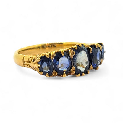 Antique Style Natural Sapphire Five Stone Ring, composed of five graduated oval blue sapphire claw set and mounted in 18ct yellow gold