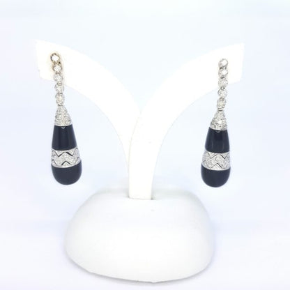 Contemporary Onyx and Diamond Drop Earrings; teardrop shaped onyx with diamond accents, suspended from graduated diamond set drops, in 18ct white gold