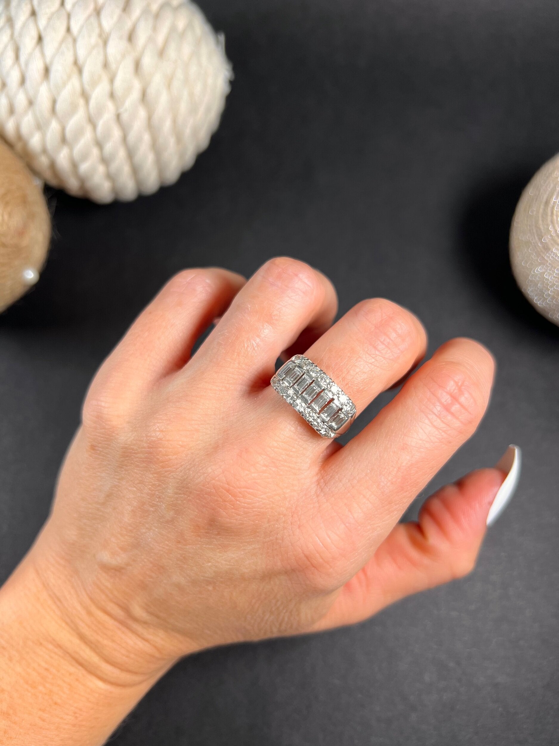 A three row diamond band ring in platinum modelled on a hand