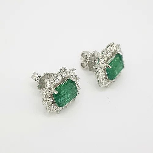 Emerald Cut Emerald and Diamond Cluster Stud Earrings; 4.25cts emerald-cut emeralds surrounded by 2.30cts round brilliant-cut diamonds, in 18ct white gold