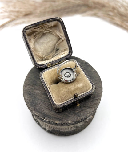 A diamond and dark blue enamel fancy cluster ring in white gold, in a ring box