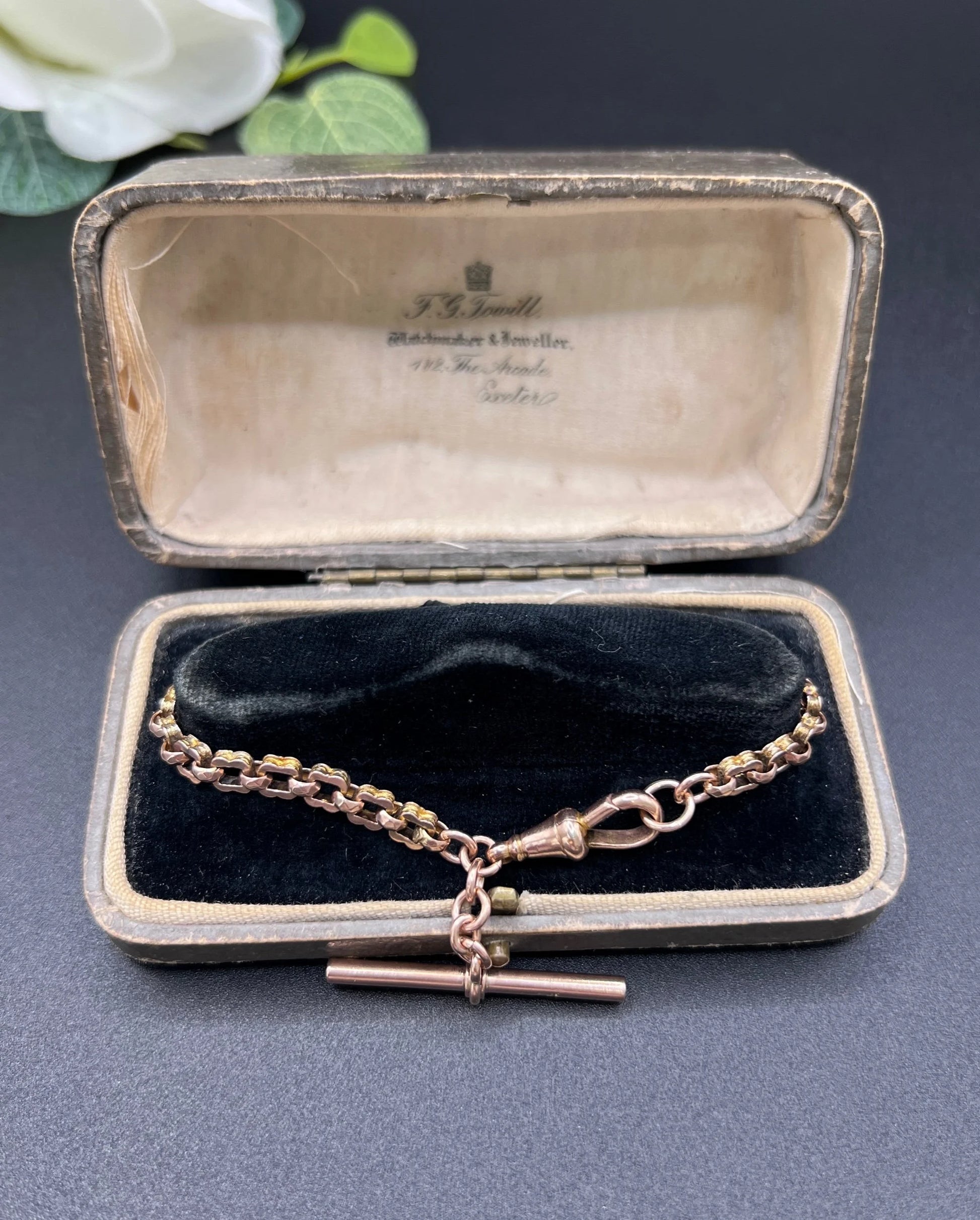 A fancy link rose gold bracelet with a T-bar and dog clip clasp, in an antique box