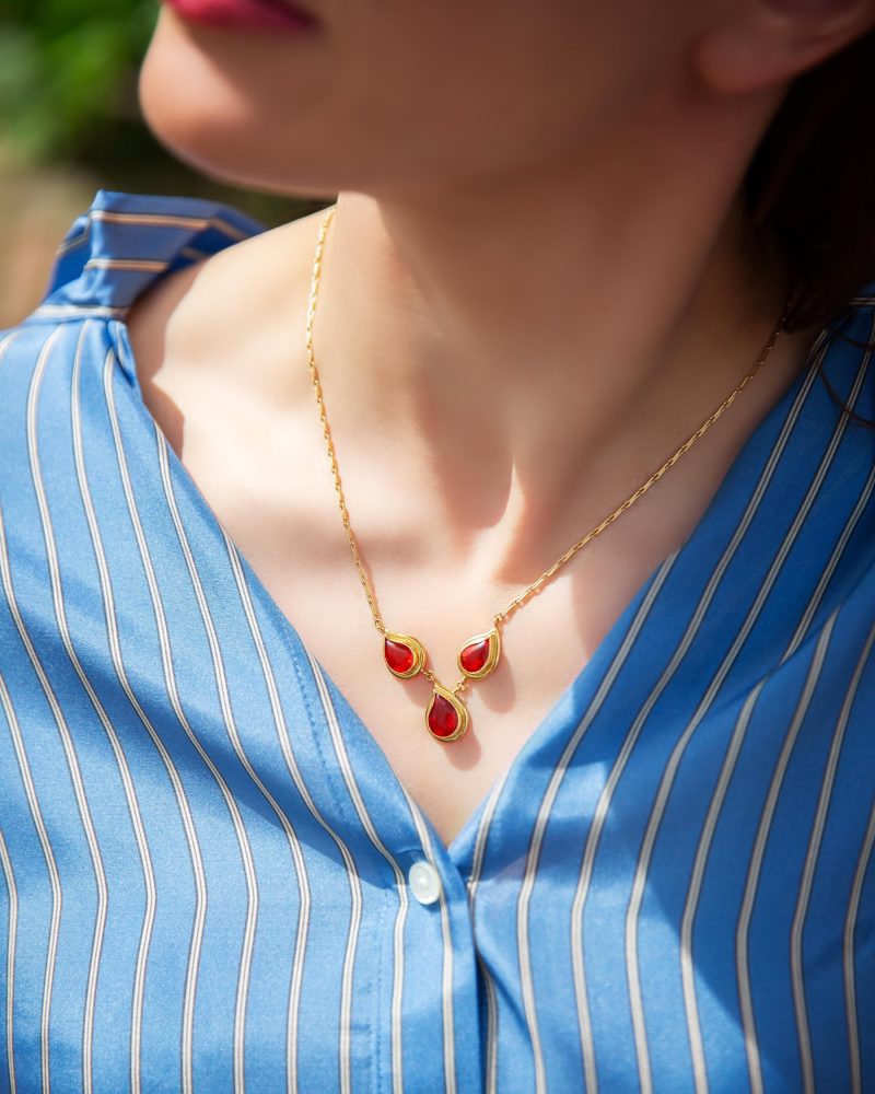 Gold pendant necklace with three fire opals.