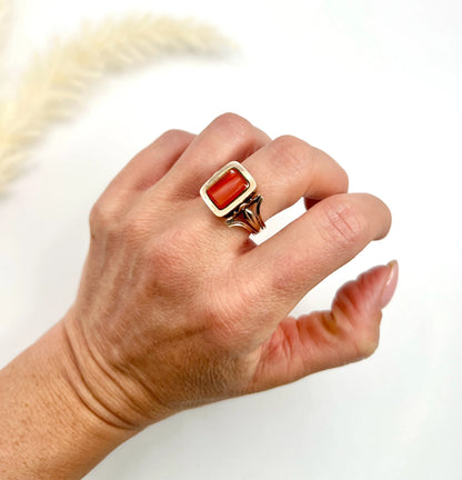 An antique carnelian mourning ring in gold, modelled on a hand