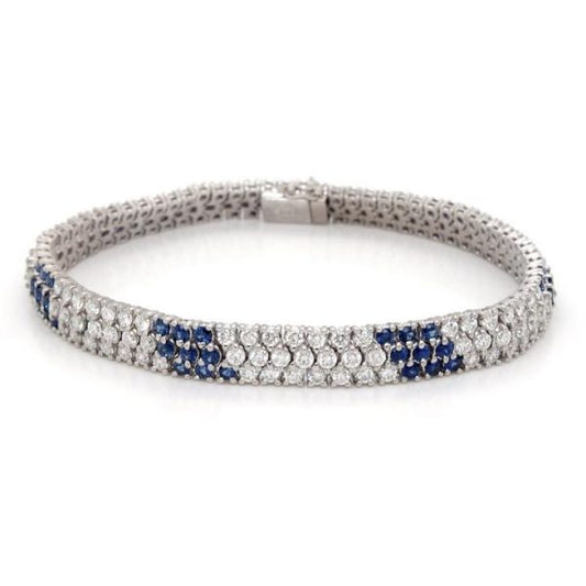Diamond Sapphire Three Row Line Bracelet; 5.80cts diamonds interspersed with sapphire-set sections, claw set in three rows, 18ct white gold
