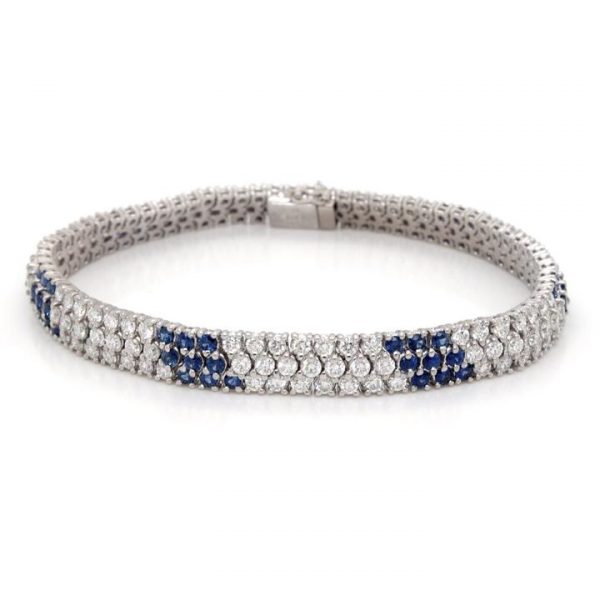 Diamond Sapphire Three Row Line Bracelet; 5.80cts diamonds interspersed with sapphire-set sections, claw set in three rows, 18ct white gold