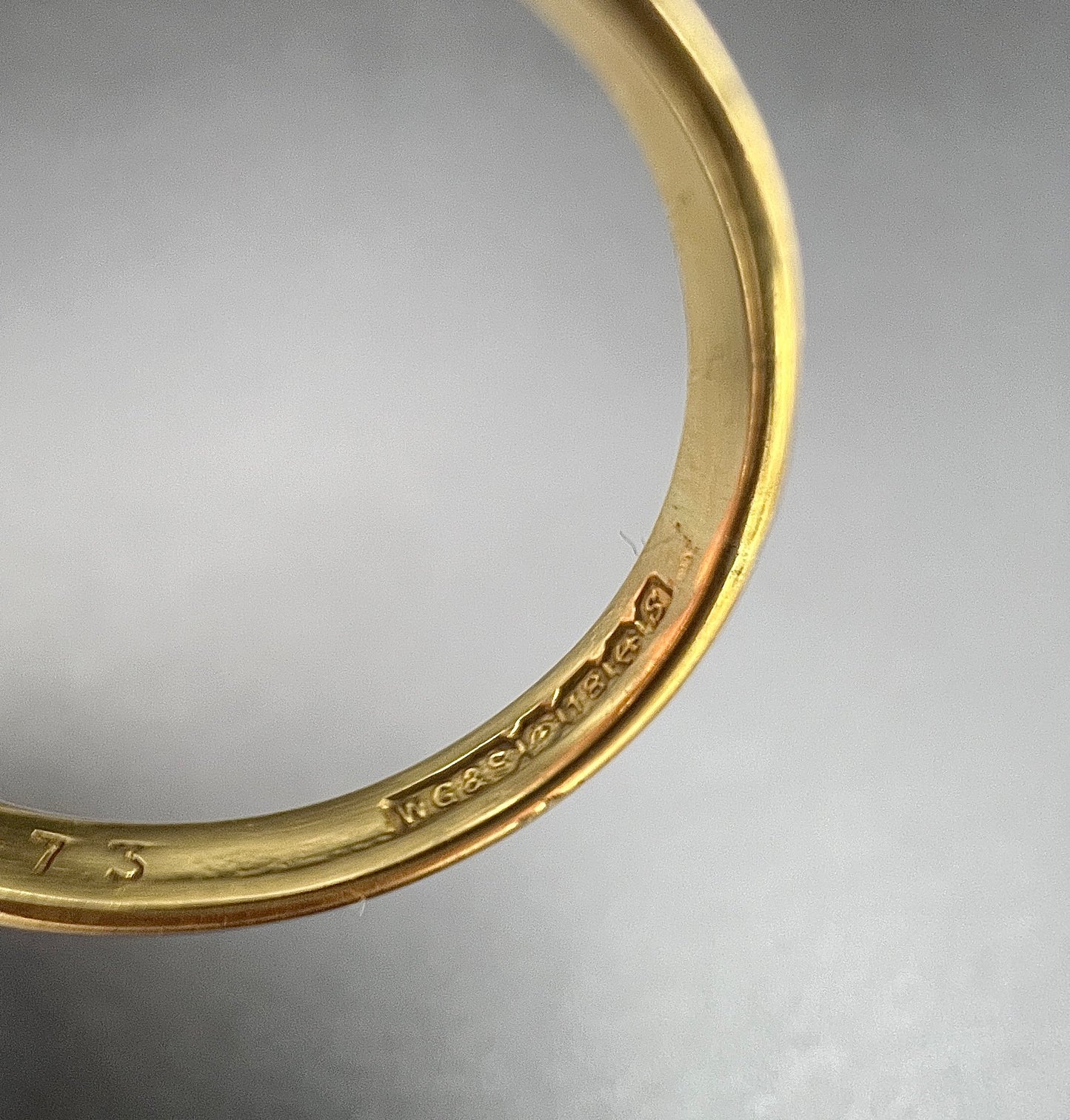 An 18 carat gold hallmark inside a ring shank