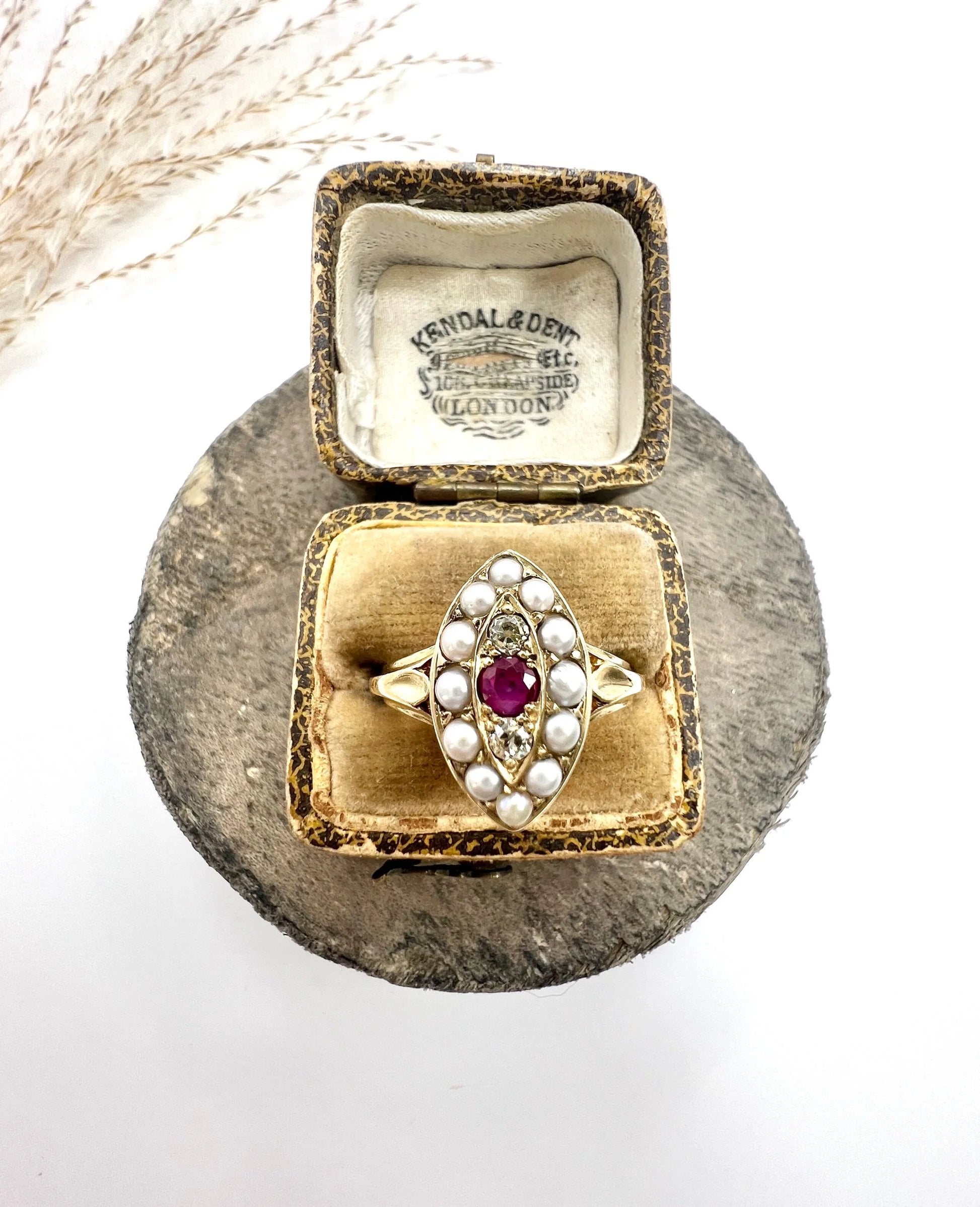 A navette shaped pearl, diamond and ruby cluster ring in yellow gold, in a ring box