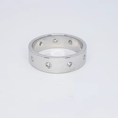Diamond and 18ct White Gold Wedding Band Ring; contemporary 18ct white gold wedding band ring set with nine circular diamonds. Ring size O 1/2
