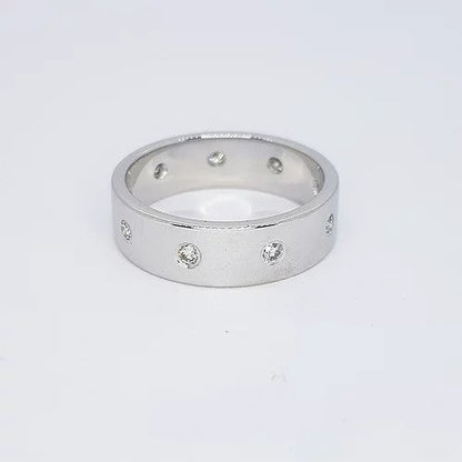 Diamond and 18ct White Gold Wedding Band Ring; contemporary 18ct white gold wedding band ring set with nine circular diamonds. Ring size O 1/2