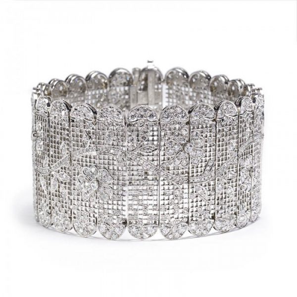Diamond Tapestry Bracelet in Platinum; set with 14.62 carats of round old-cut and single-cut diamonds, in a sweeping floral pattern depicting flowers and leaves upon a branch, with scalloped edges