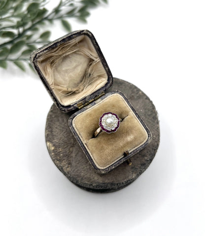 A pearl, diamond and ruby fancy cluster ring in platinum and yellow gold, in a ring box