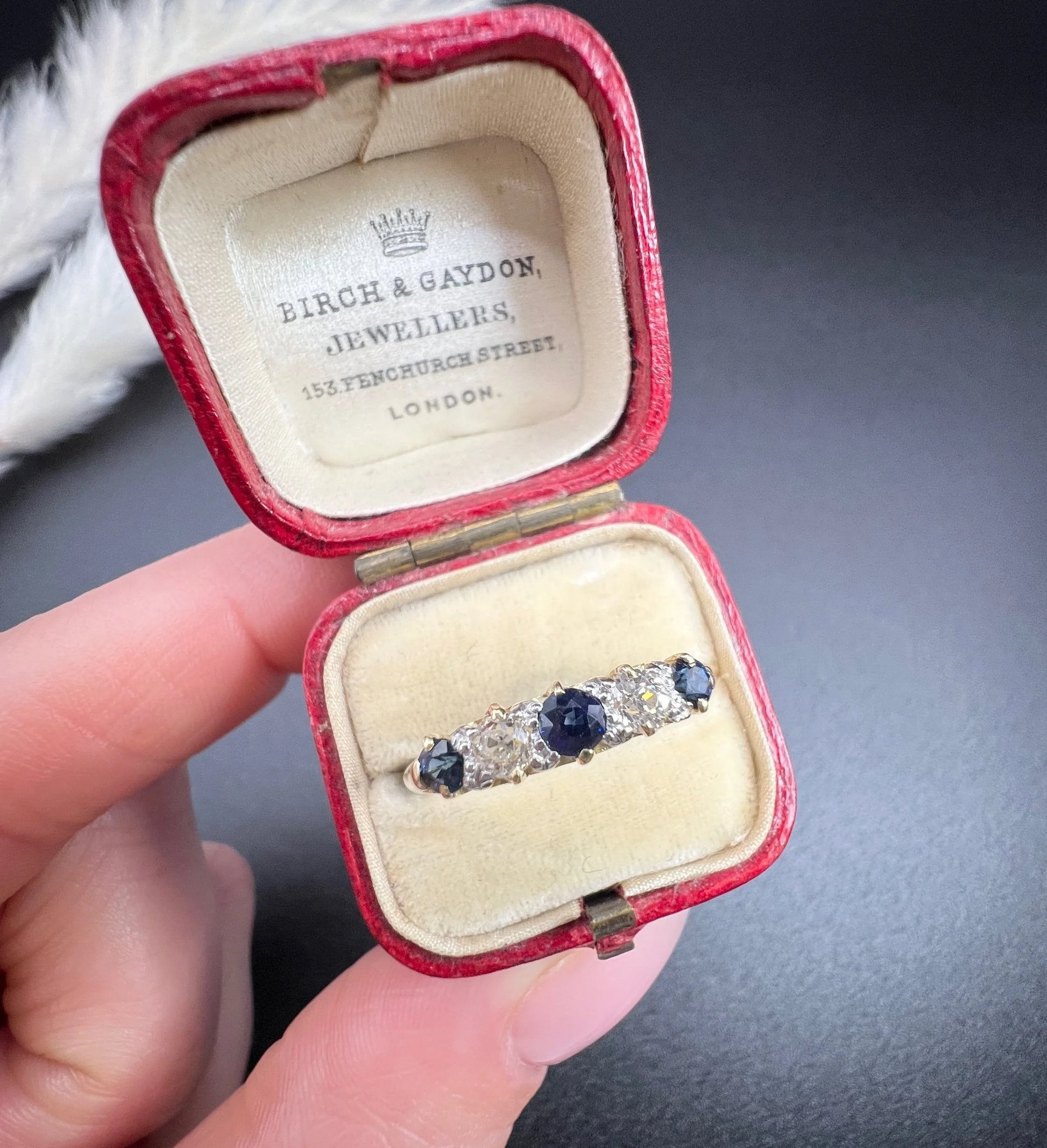 A yellow gold five stone sapphire and diamond carved half hoop ring, in a ring box
