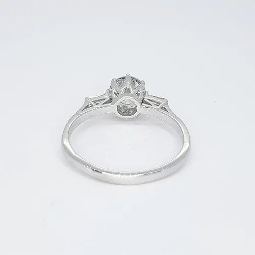 Diamond Solitaire Engagement Ring; round brilliant-cut diamond flanked by baguette diamond set shoulders, 1.04 carat total, in platinum