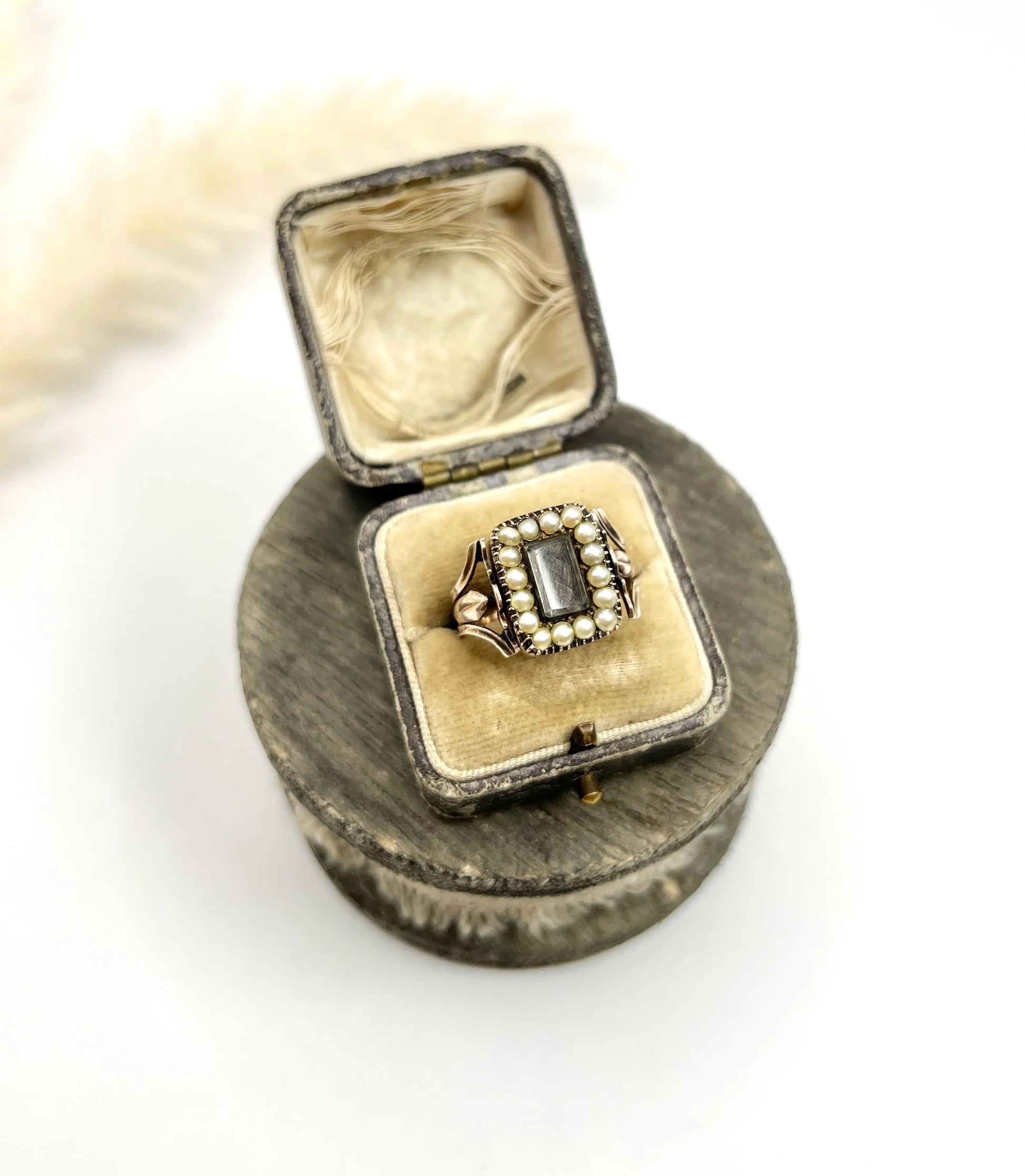 An antique seed pearl mourning ring in gold, in a ring box