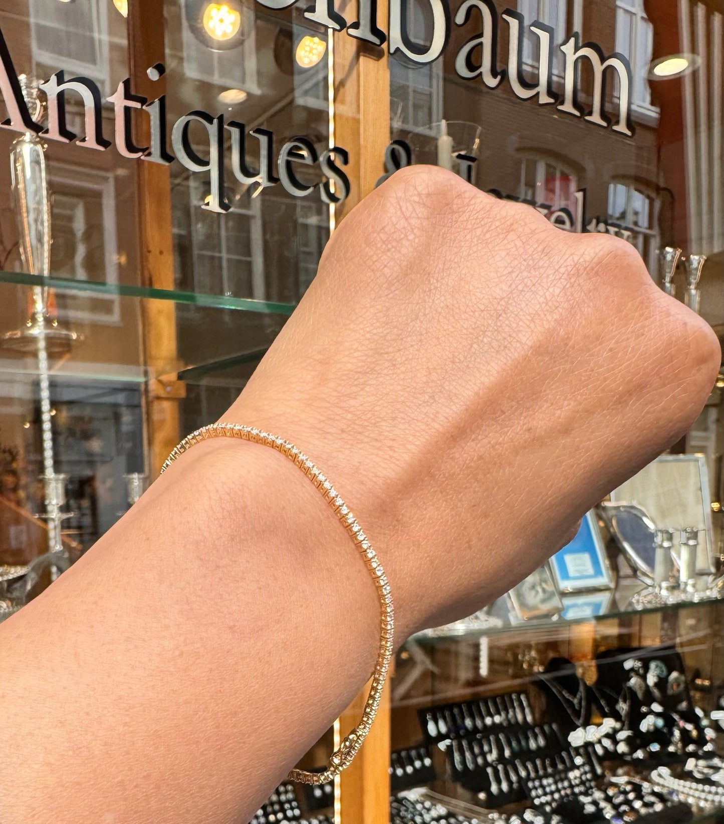 A yellow gold diamond line bracelet, modelled on a wrist