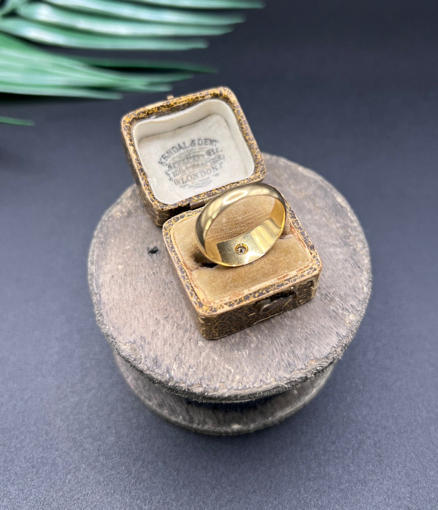 A single stone old cut diamond gypsy band ring in yellow gold