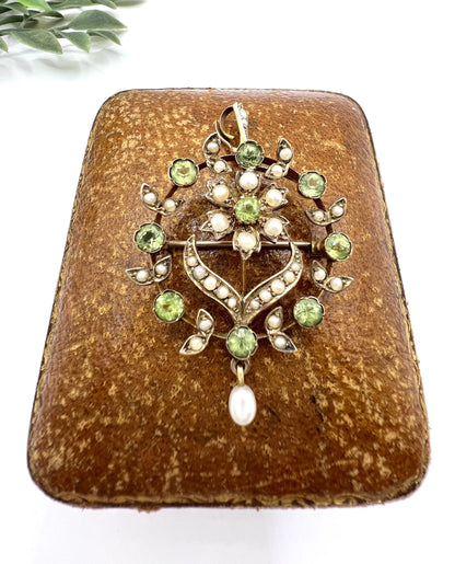 A peridot and pearl floral circle brooch/pendant in yellow gold
