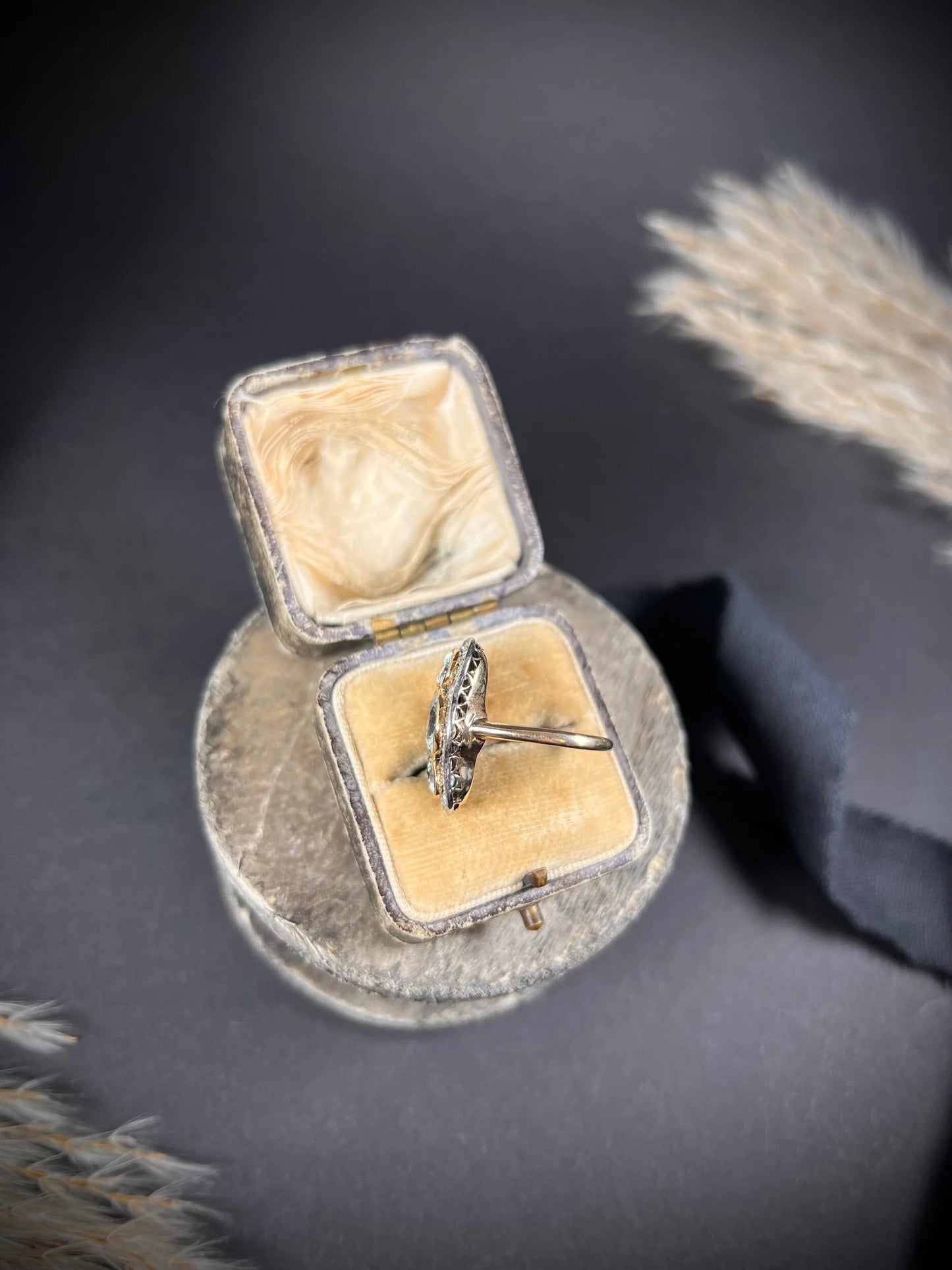 An aquamarine and diamond cocktail cluster ring, in an antique ring box