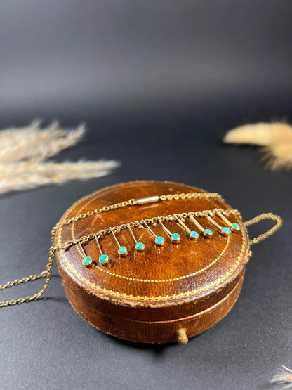 A gold negligee pendant necklace with turquoise drops