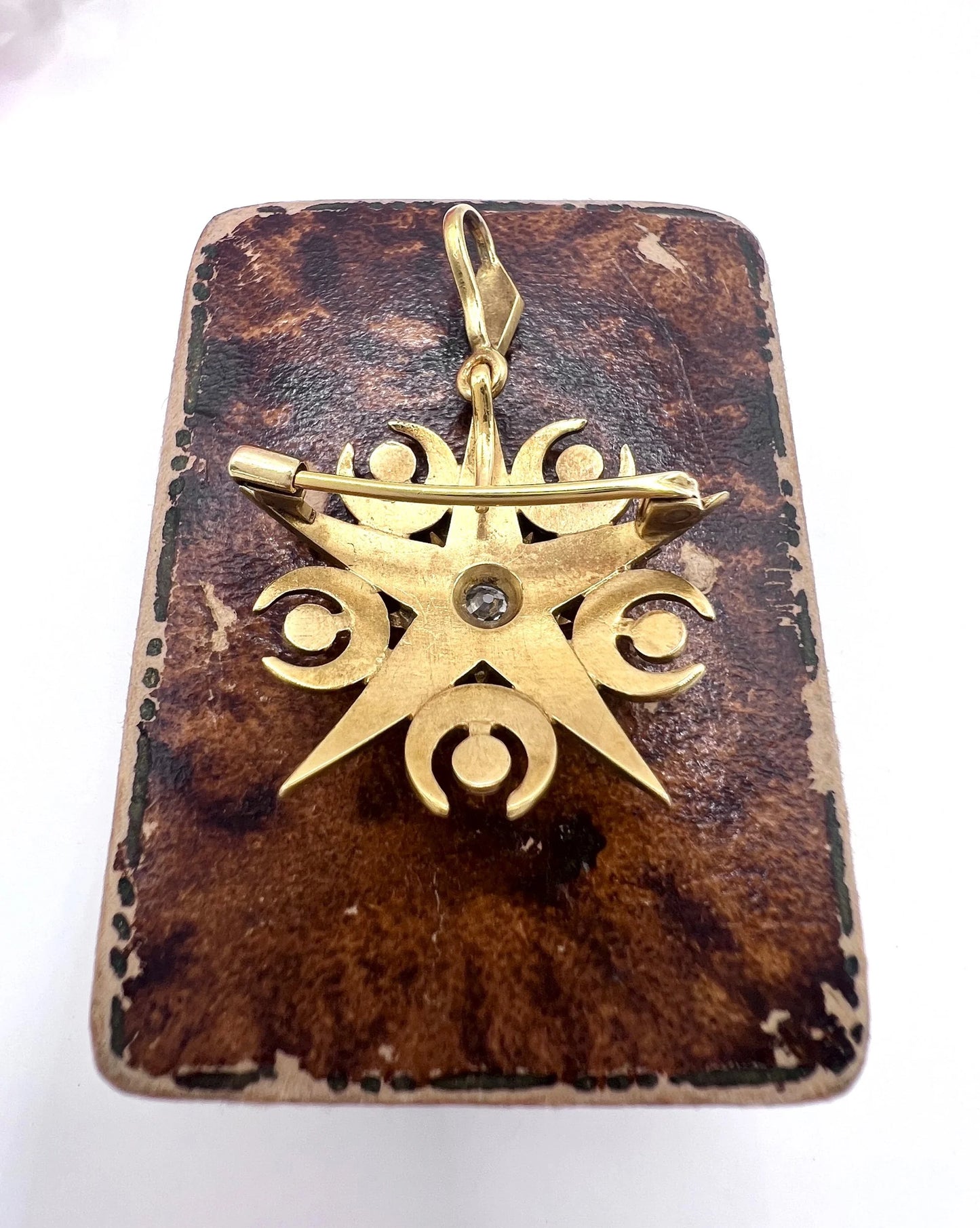 A yellow gold star and crescent brooch/pendant with pearls and a diamond centre