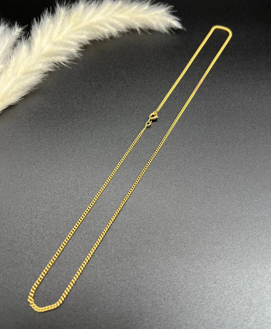A fine curb link chain necklace in yellow gold