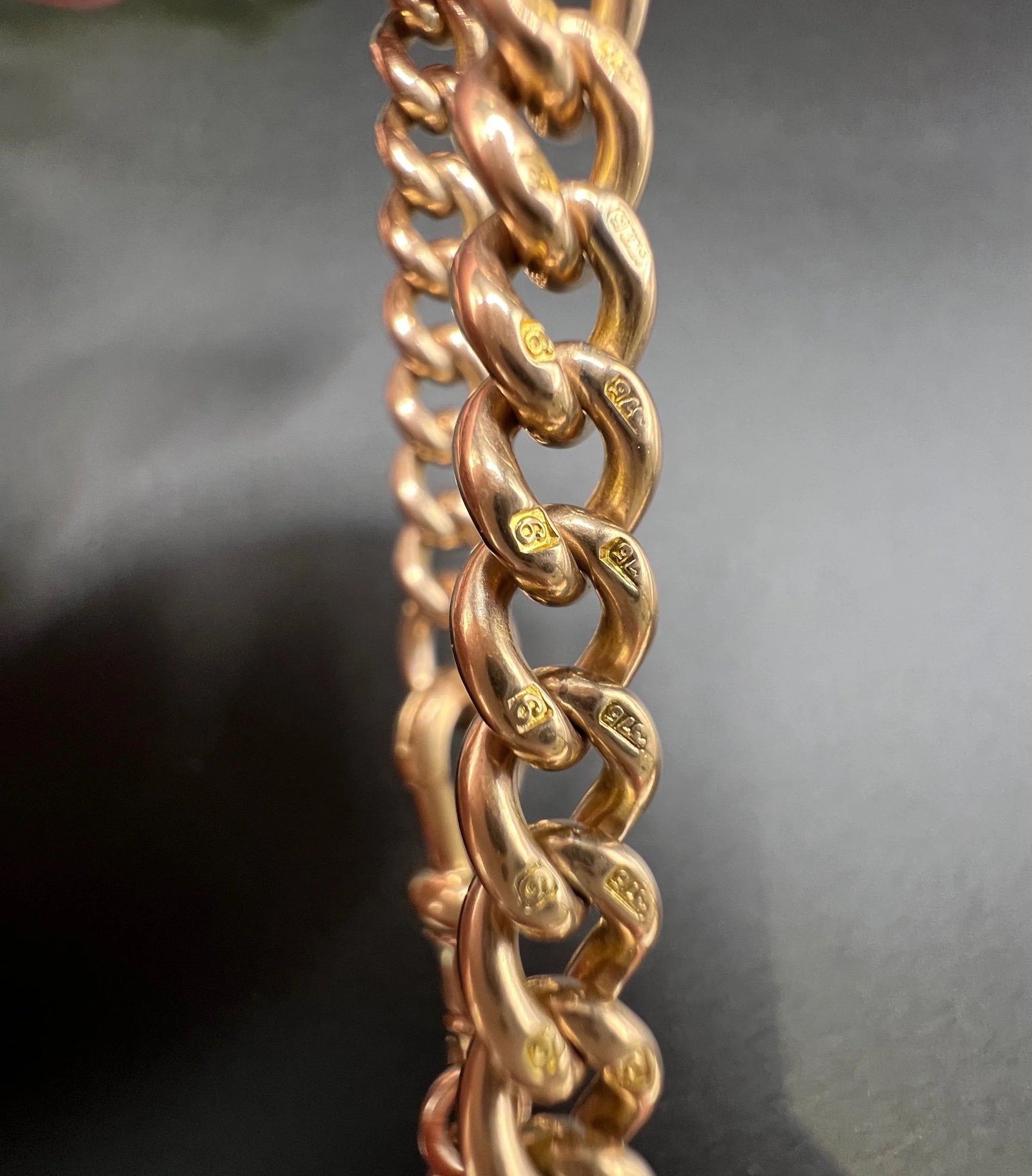 Close-up of stamped gold curb bracelet links