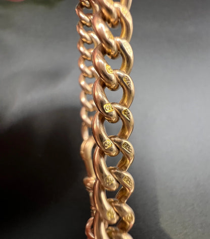 Close-up of stamped gold curb bracelet links