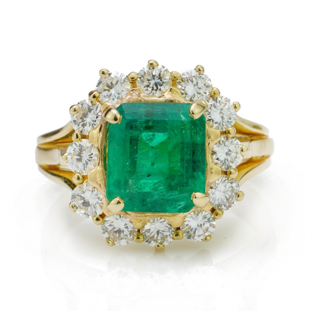 Antique emerald ring 3.80ct Emerald Cut Emerald and Diamond Cluster Ring; central 3.8ct emerald-cut emerald within a surround of 12 brilliant-cut diamonds totalling 0.96 carats, in 18ct yellow gold with eye-catching triple-split shoulders