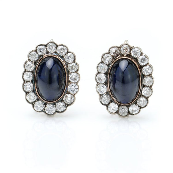 Antique Russian Cabochon Sapphire and Old Cut Diamond Cluster Earrings; 12cts cabochon blue sapphires surrounded by 6.40cts old-cut diamonds, in 14ct yellow gold with post and clip fittings, Circa 1850s