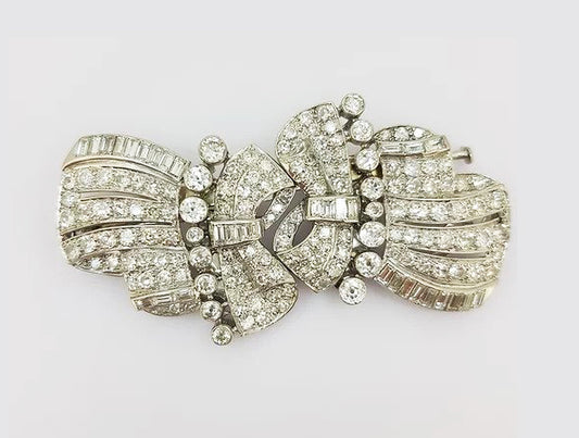 Vintage Diamond Double Clip Bow Brooch; set with baguette and brilliant-cut diamonds, in 18ct white gold. Total diamond weight: approximately 10.00 carats.