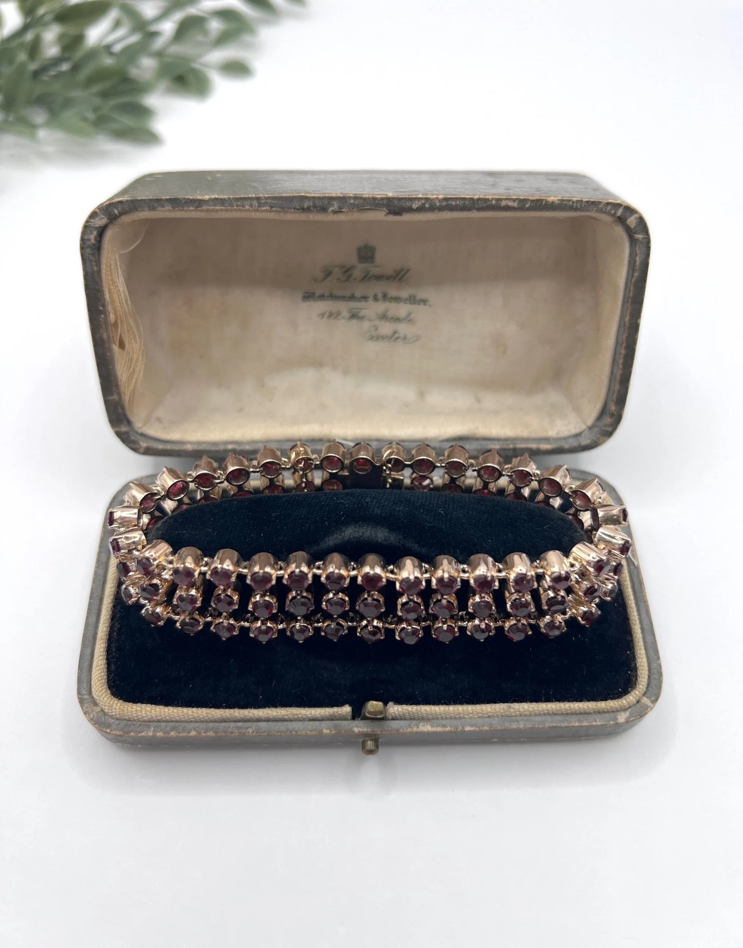 A triple row garnet bracelet in rose gold, in an antique box