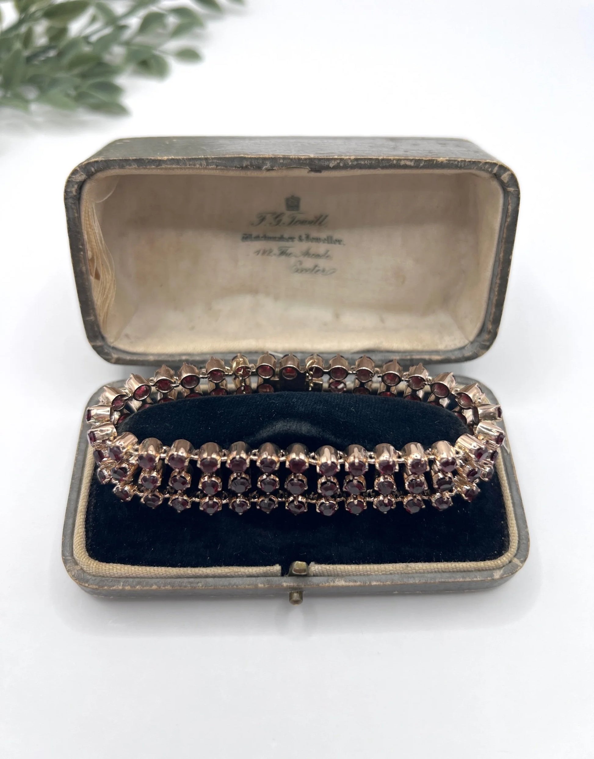 A triple row garnet bracelet in rose gold, in an antique box